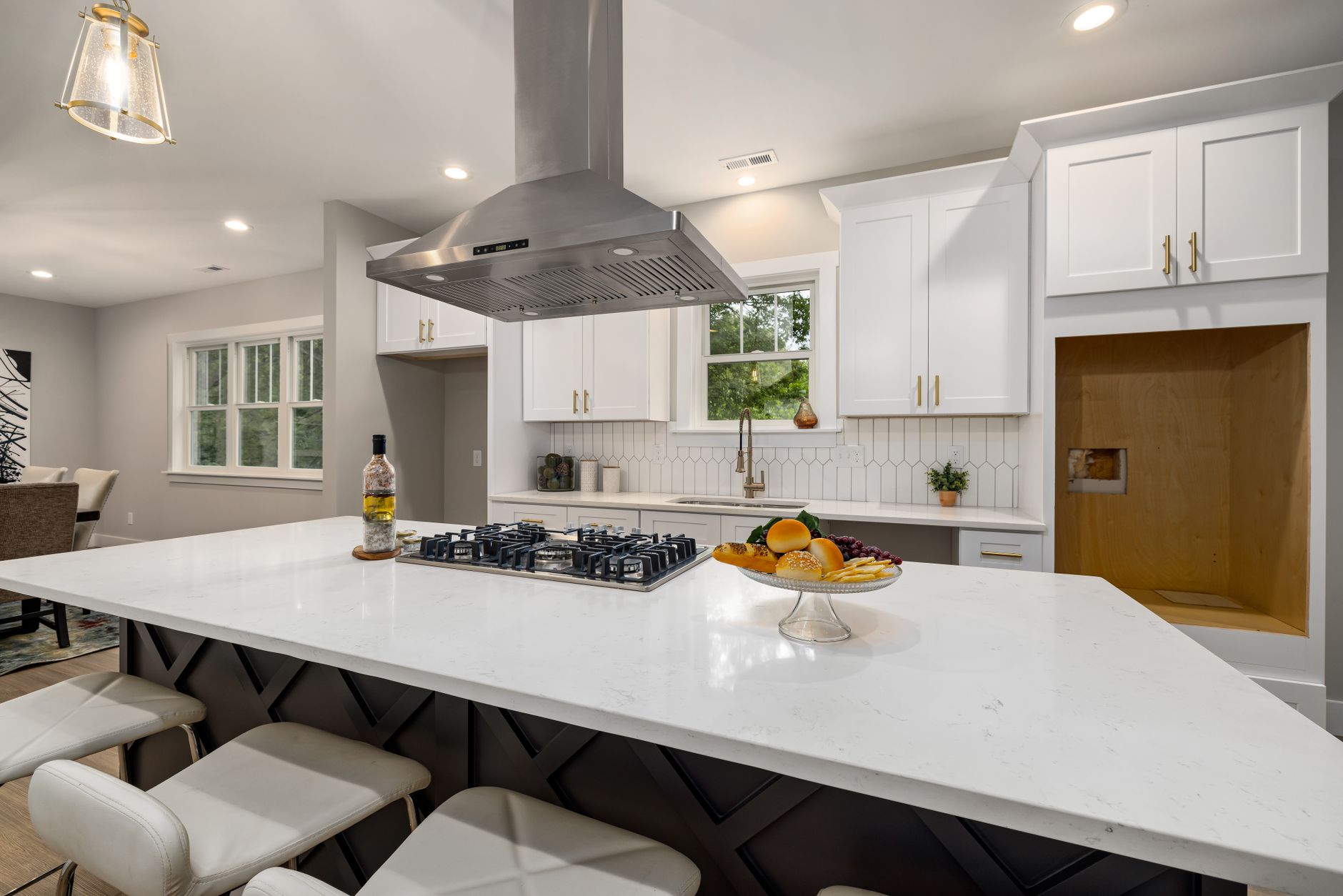 Sleek modern kitchen with white cabinets, island, and stainless range hood for a contemporary look in Irvine, CA